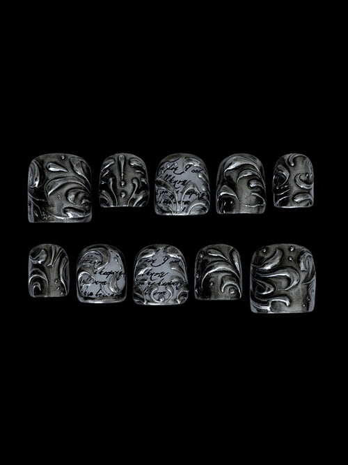 FILIGREE très court — Dix press-on très courts noirs et argentés aux arabesques en relief, sur fond noir