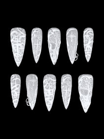 PHANTOM — Dix press-on Stiletto blancs et translucides aux motifs en relief, sur fond noir