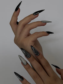 UMBRA — Vue de profil des ongles Stiletto noirs et argentés sur deux mains